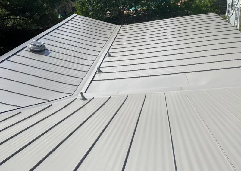Solar attic fan installed on a metal roof for Roof Ventilation in Atoka